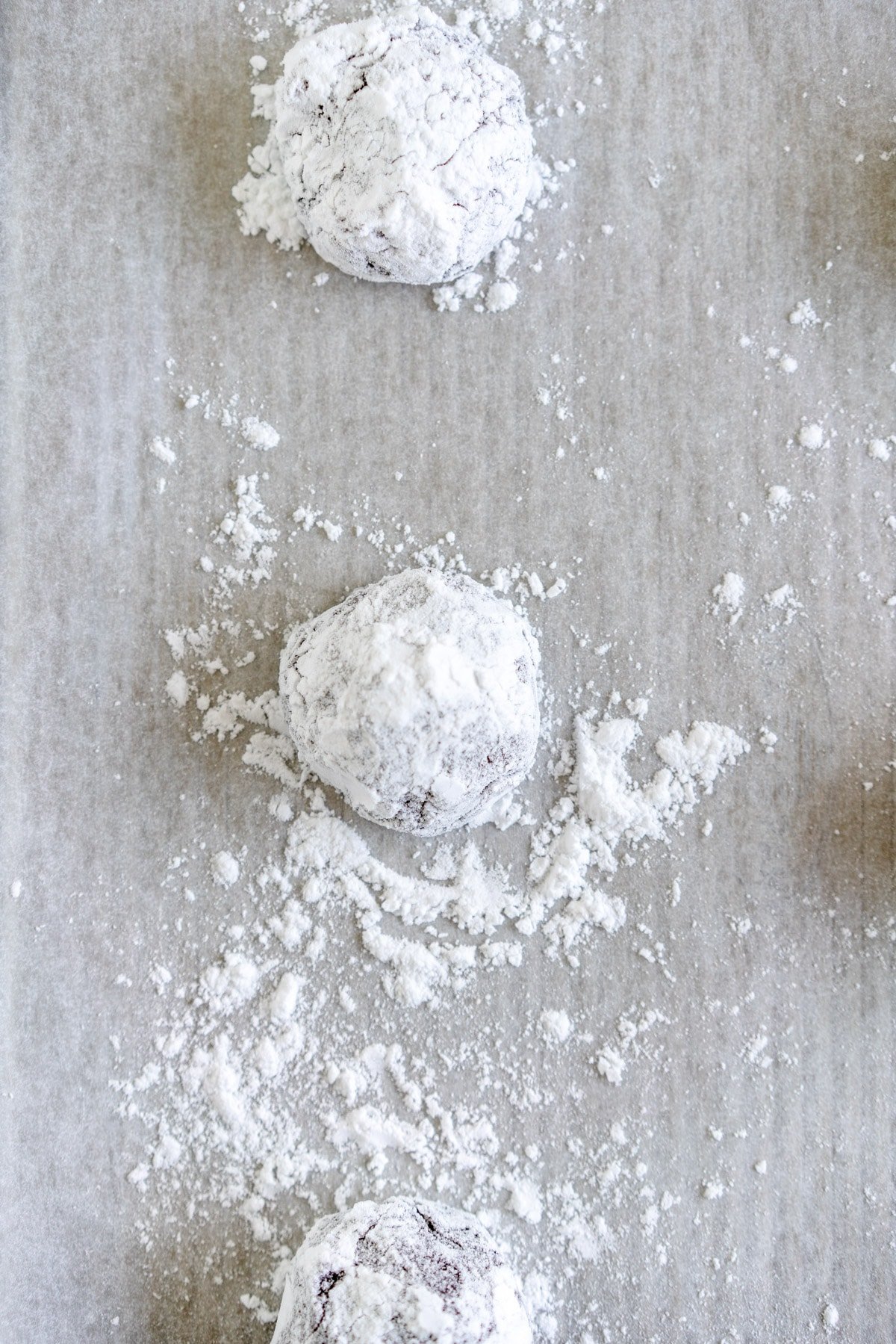 cookie dough in powdered sugar on pan