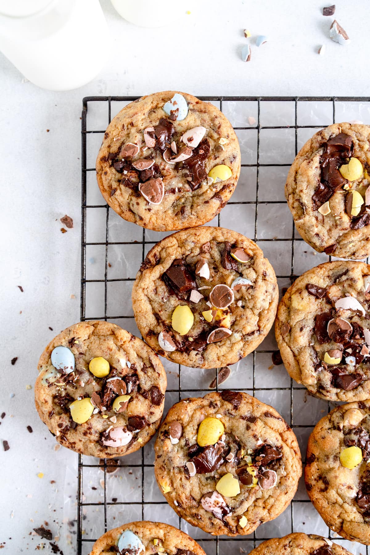 top corner shot of chocolate chip cookies on rack with milk jug