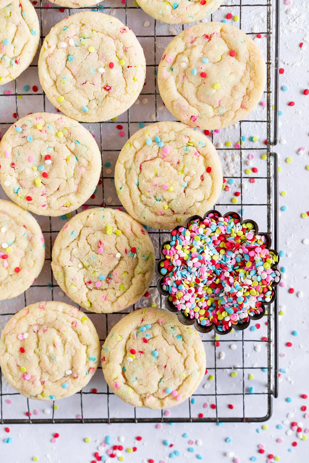 funfetti cookies with dish of sprinkles next to it