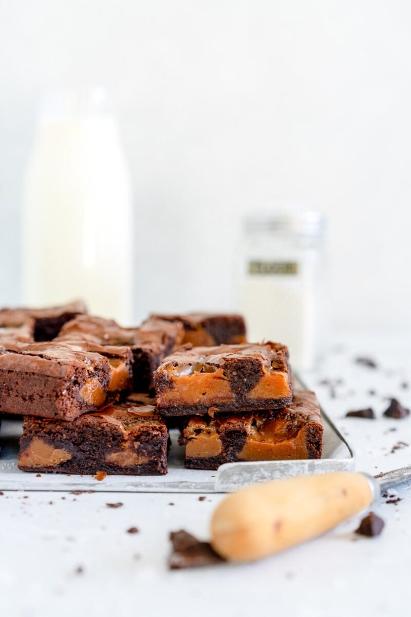 stacked caramel brownie on a tray