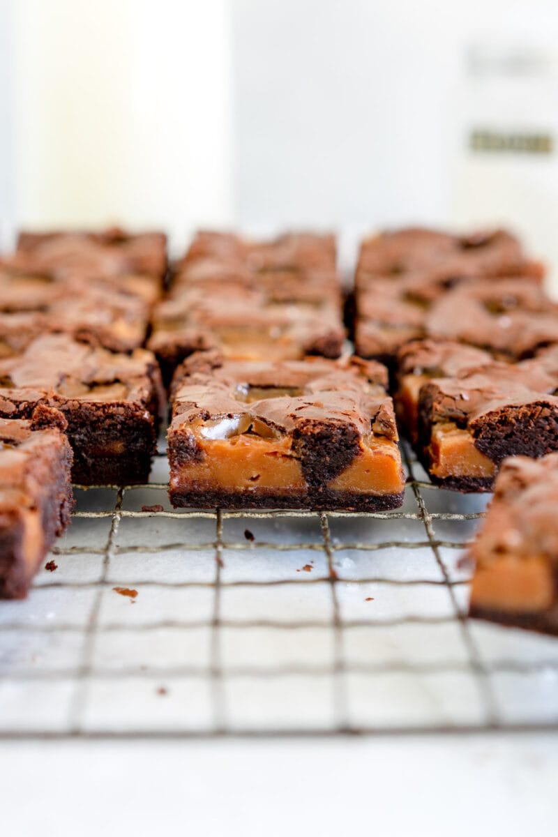 pieces of caramel brownie on a wire rack