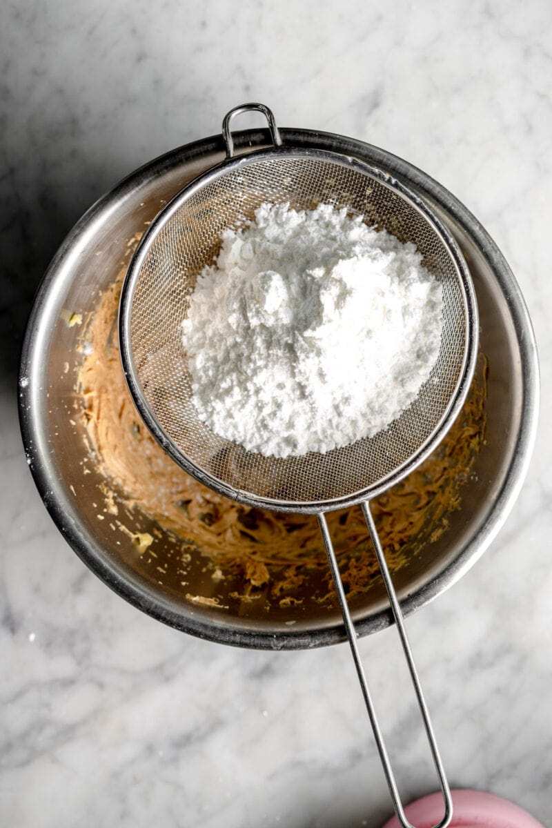 adding powdered sugar to peanut butter mixture