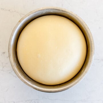 risen white bread dough in a bowl
