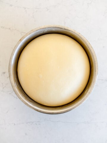 risen white bread dough in a bowl