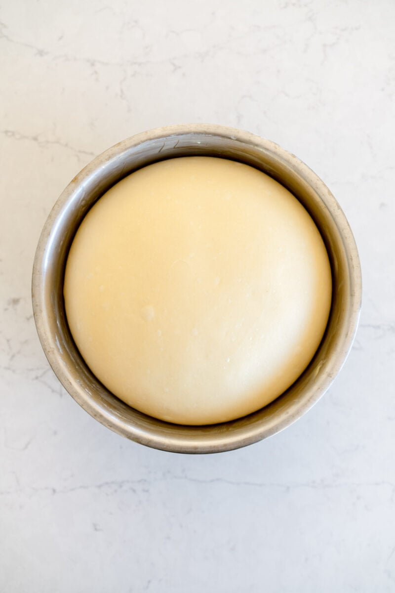 risen white bread dough in a bowl