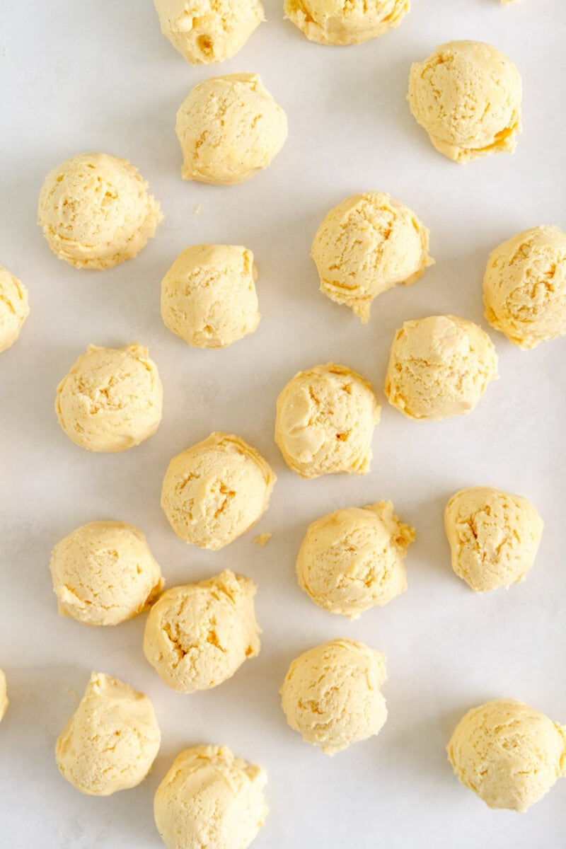 balls of cookie dough on sheet pan