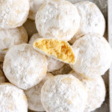 pan of snowball cookies with one broken open