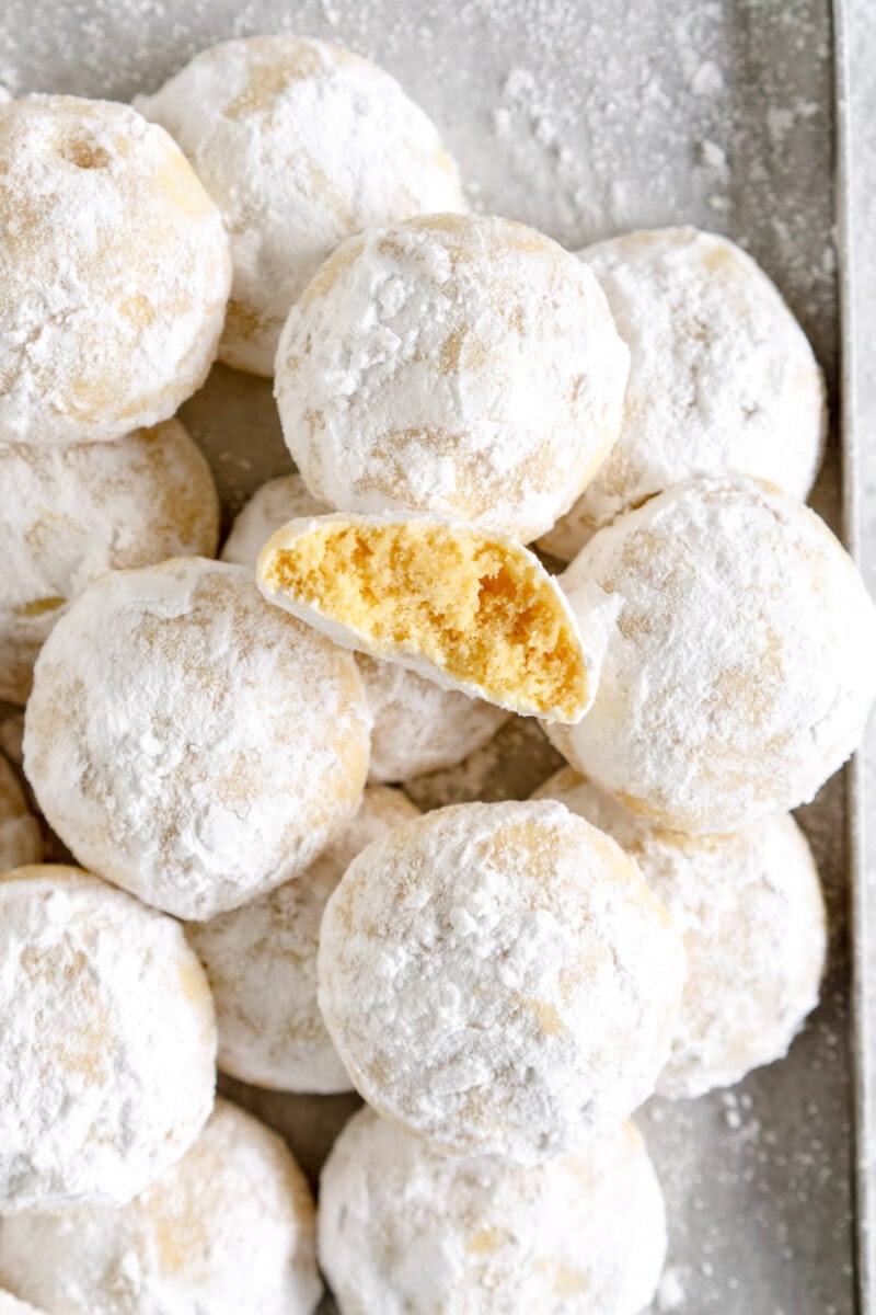 pan of snowball cookies with one broken open