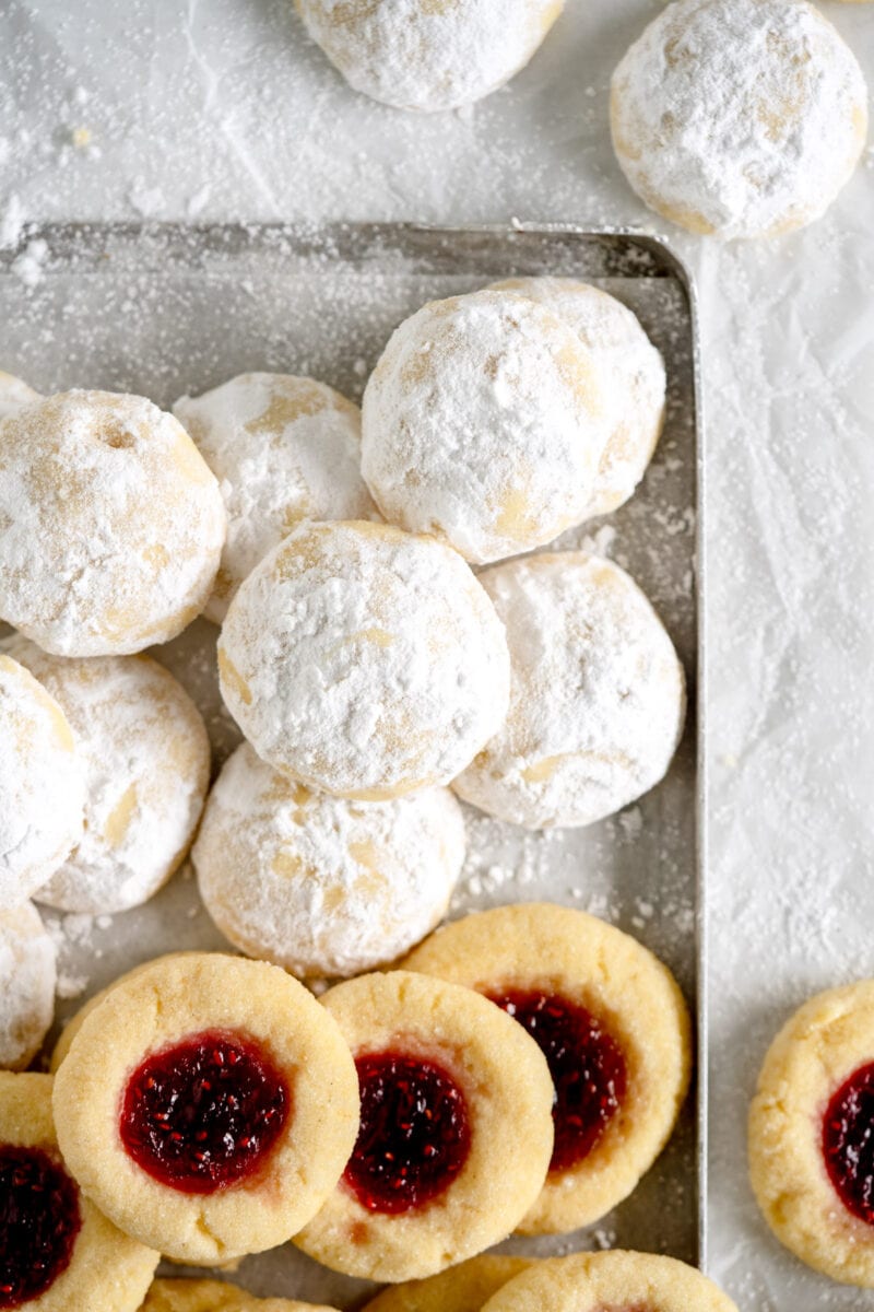snowball cookies on pan with thumbprints