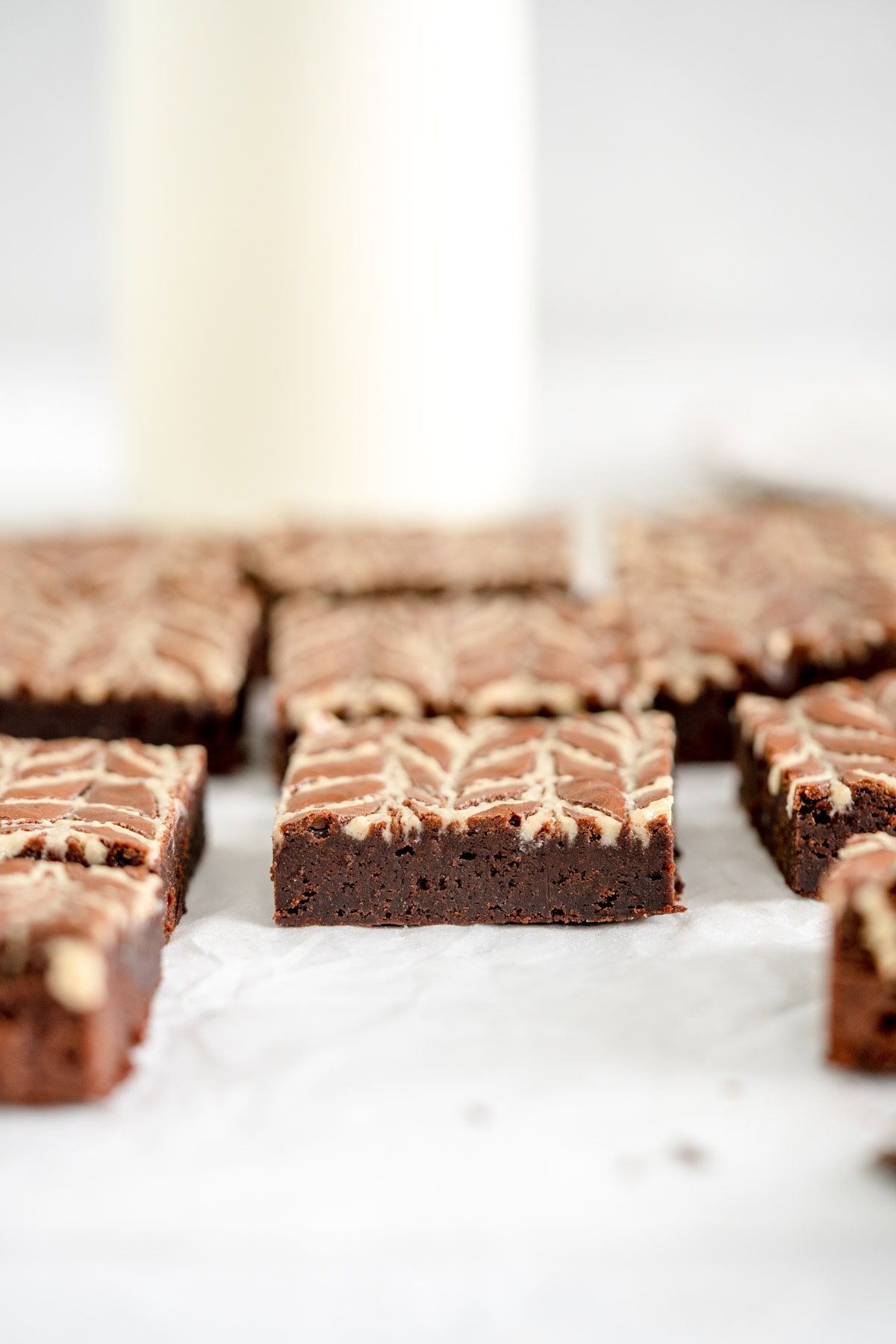 sliced tahini brownie side on shot on parchment paper