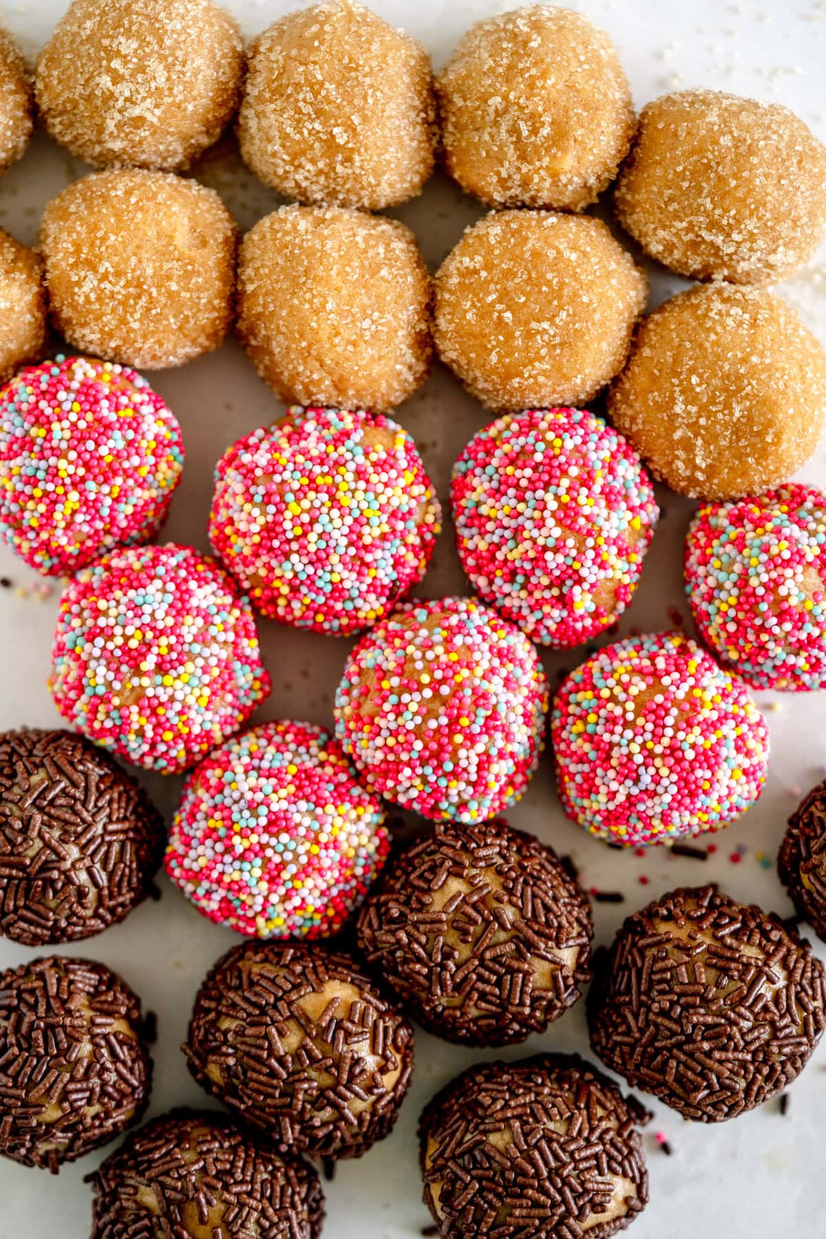 rolling cookies in sprinkles
