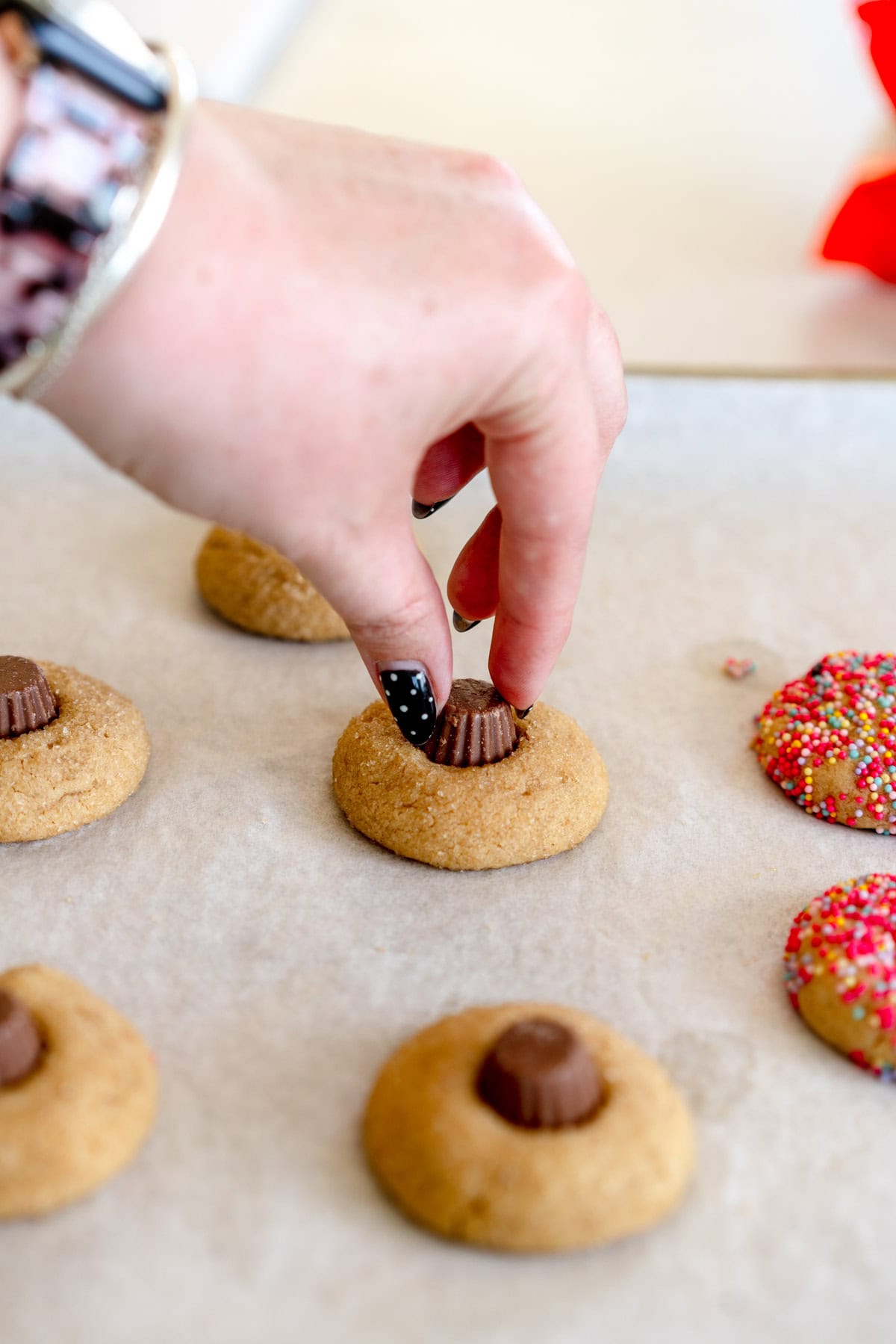 adding peanut butter cups to cookies