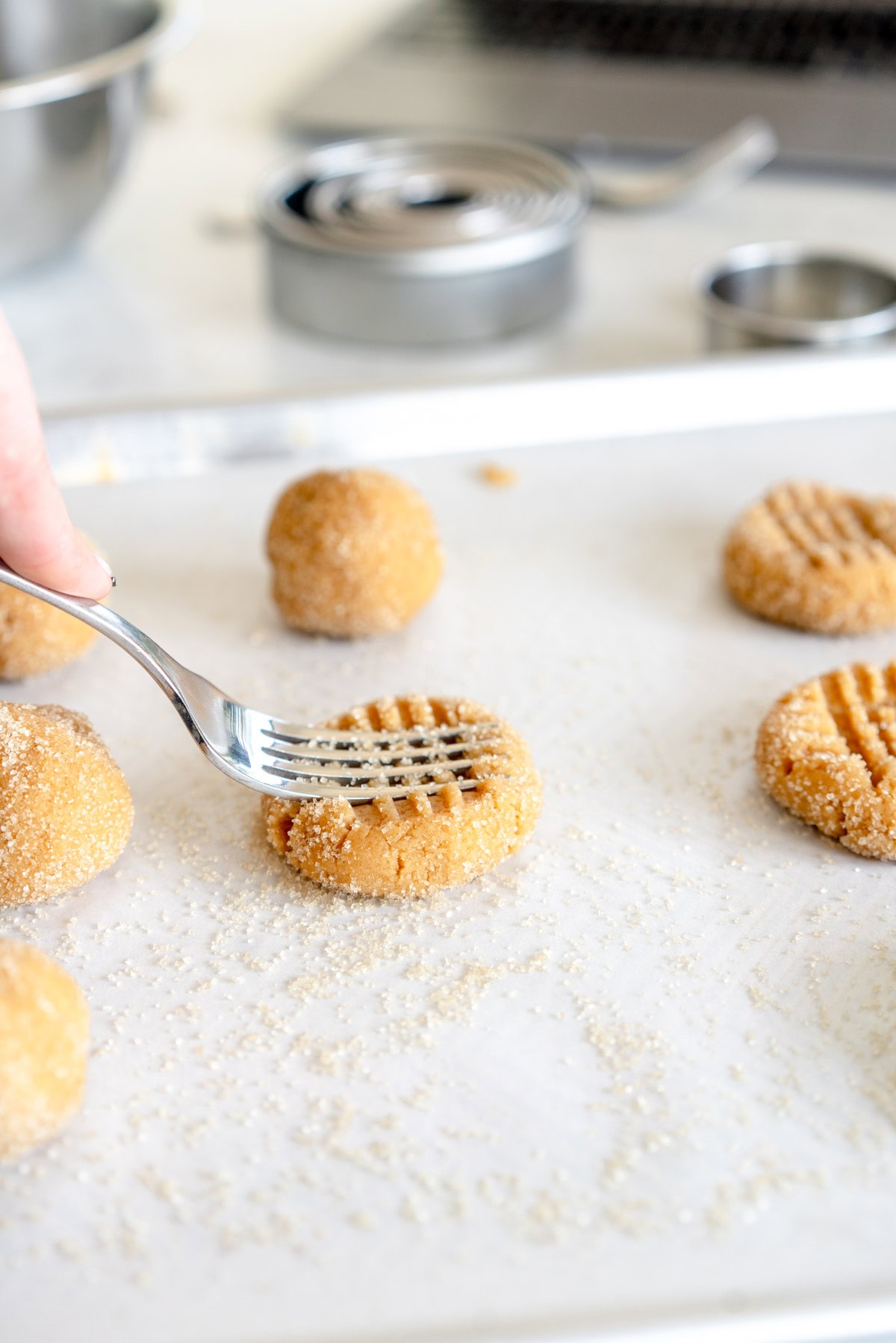 pressing down on cookies with fork