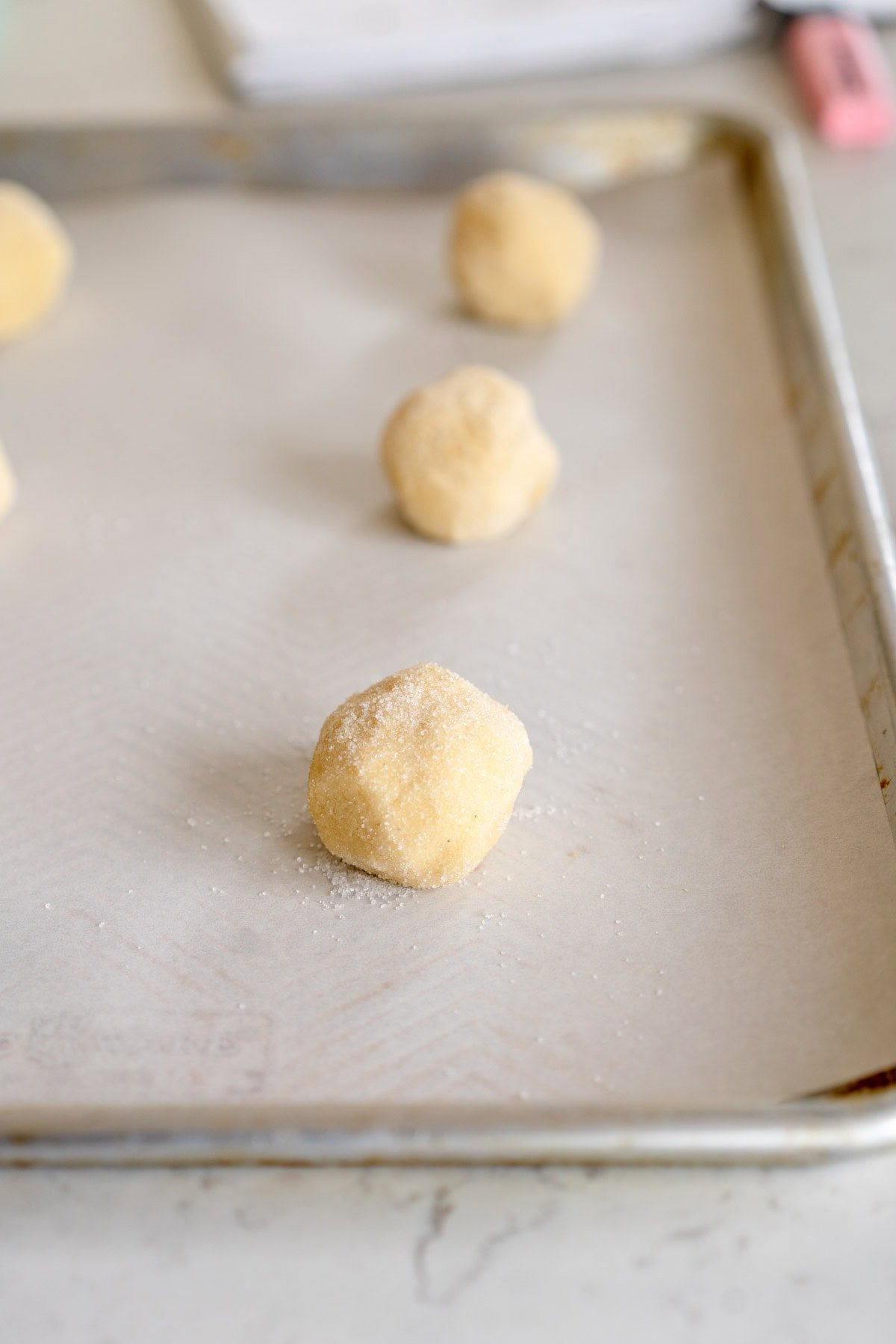 balls of cookie dough on sheet pan