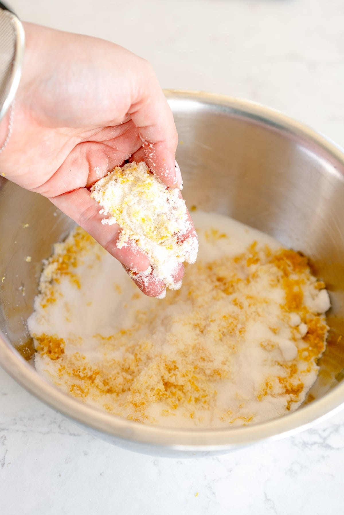 adding lemon zest to sugar for cake
